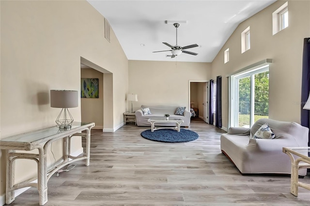 7308 Maryland Ave, Hudson, FL 34667 - living room with ceiling fan, high vaulted ceiling, light wood-style flooring, and baseboards