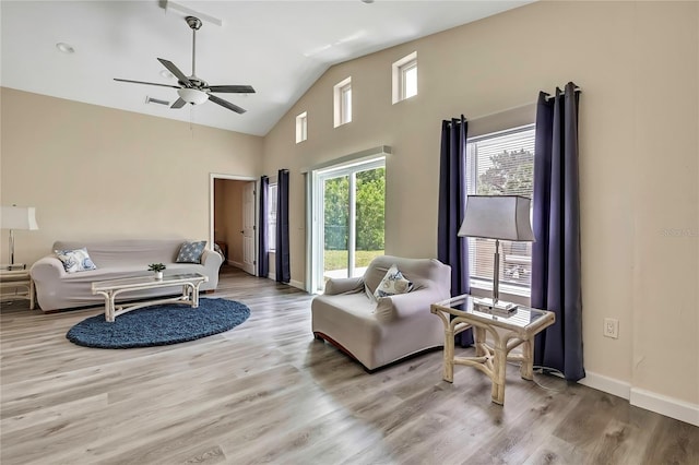 7308 Maryland Ave, Hudson, FL 34667 - living room with a ceiling fan, wood finished floors, baseboards, and high vaulted ceiling