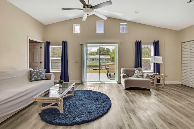 7308 Maryland Ave, Hudson, FL 34667 - living room with a ceiling fan, high vaulted ceiling, wood finished floors, and baseboards