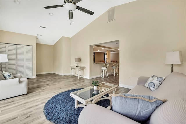 7308 Maryland Ave, Hudson, FL 34667 - living area featuring a ceiling fan, wood finished floors, high vaulted ceiling, and baseboards