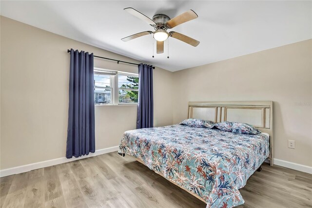 7308 Maryland Ave, Hudson, FL 34667 - bedroom featuring baseboards, wood finished floors, and ceiling fan