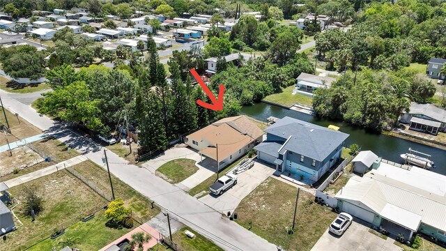 7308 Maryland Ave, Hudson, FL 34667 - aerial view of residential area featuring a large body of water and a tree filled landscape