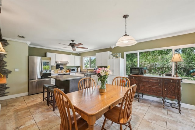 4468 Maraldo Ave, North Port, FL 34287 - dining room featuring baseboards, a ceiling fan, crown molding, and light tile patterned floors