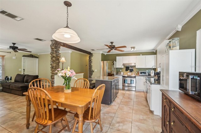 4468 Maraldo Ave, North Port, FL 34287 - dining area featuring ceiling fan, crown molding, light tile patterned flooring, and decorative columns
