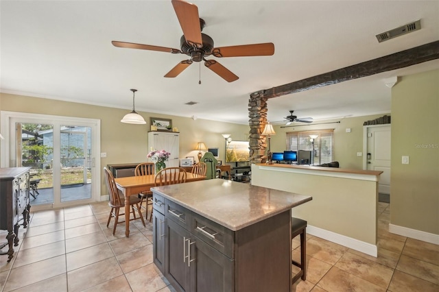 4468 Maraldo Ave, North Port, FL 34287 - kitchen with ceiling fan, a breakfast bar area, a center island, light tile patterned flooring, and hanging light fixtures