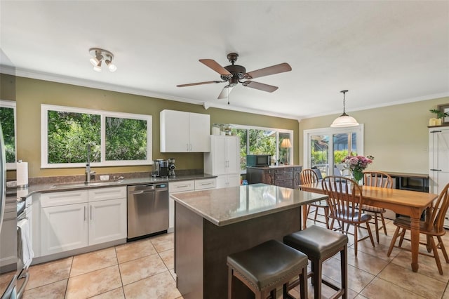 4468 Maraldo Ave, North Port, FL 34287 - kitchen featuring stainless steel dishwasher, a sink, light tile patterned flooring, white cabinets, and crown molding