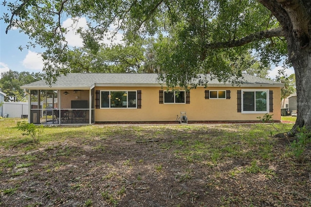 4468 Maraldo Ave, North Port, FL 34287 - rear view of house with a sunroom, stucco siding, and fence
