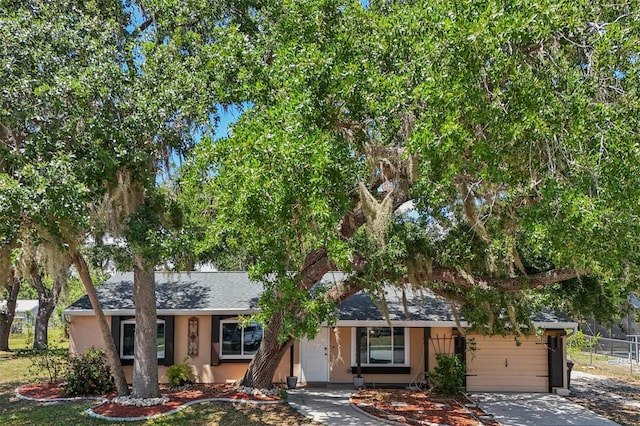 4468 Maraldo Ave, North Port, FL 34287 - view of front facade with a garage, fence, driveway, stucco siding, and a shingled roof