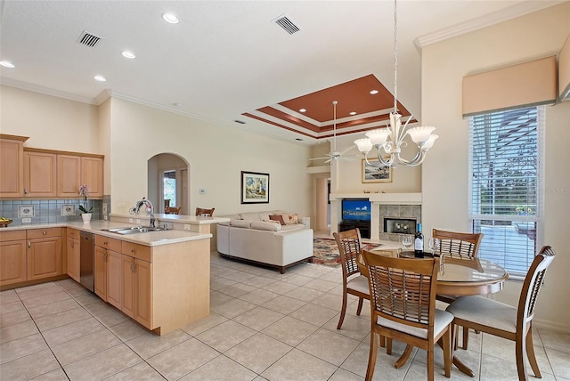 766 Shadow Bay Way, Osprey, FL 34229 - kitchen with crown molding, arched walkways, open floor plan, light brown cabinets, and light tile patterned floors