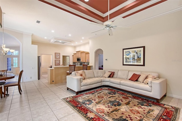 766 Shadow Bay Way, Osprey, FL 34229 - living room featuring arched walkways, ornamental molding, a chandelier, light tile patterned floors, and ceiling fan