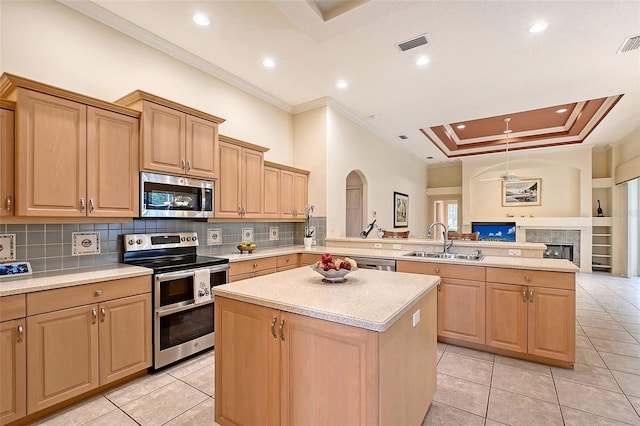 766 Shadow Bay Way, Osprey, FL 34229 - kitchen with appliances with stainless steel finishes, ornamental molding, a peninsula, light countertops, and light tile patterned floors