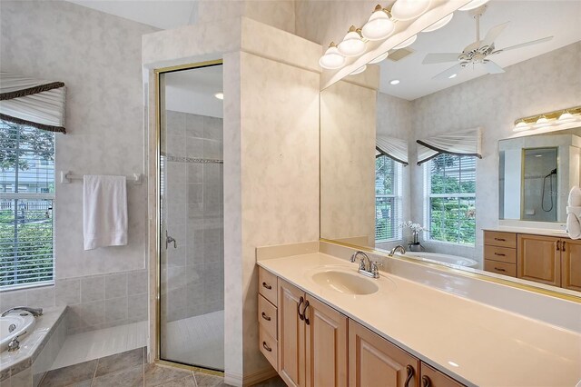 766 Shadow Bay Way, Osprey, FL 34229 - bathroom with vanity, a shower stall, a bath, and a ceiling fan