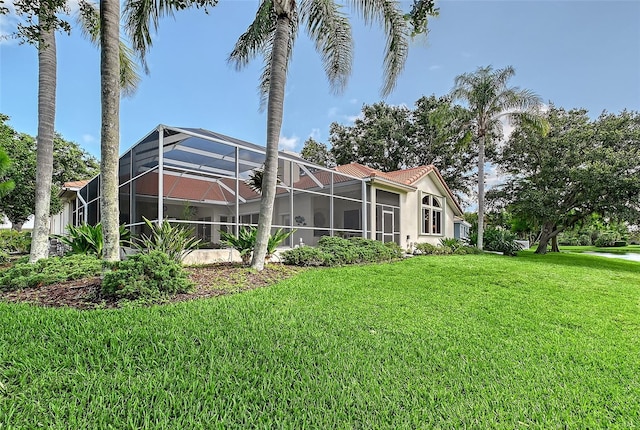 766 Shadow Bay Way, Osprey, FL 34229 - rear view of property with a yard, glass enclosure, and stucco siding