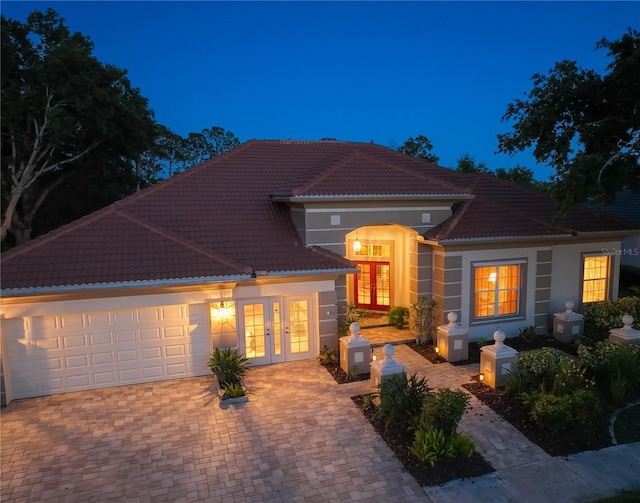 766 Shadow Bay Way, Osprey, FL 34229 - view of front of property with french doors, a tile roof, a garage, and stucco siding