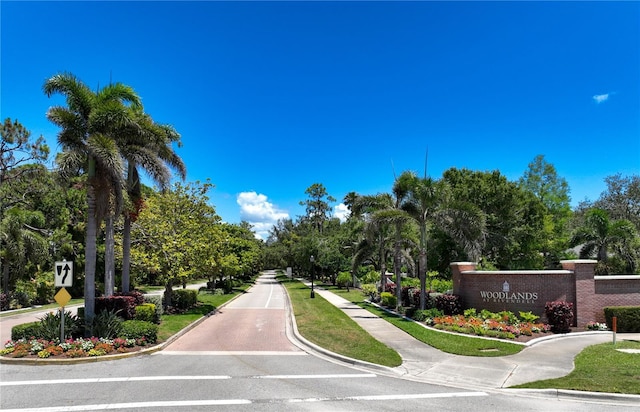 766 Shadow Bay Way, Osprey, FL 34229 - view of asphalt street with curbs, sidewalks, traffic signs, and view of scattered trees