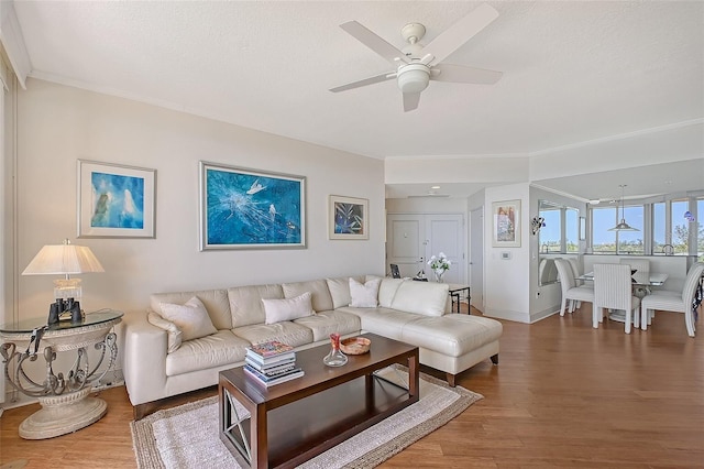 3070 Grand Bay Blvd Unit 644, Longboat Key, FL 34228 - living room featuring a ceiling fan, wood finished floors, baseboards, and ornamental molding