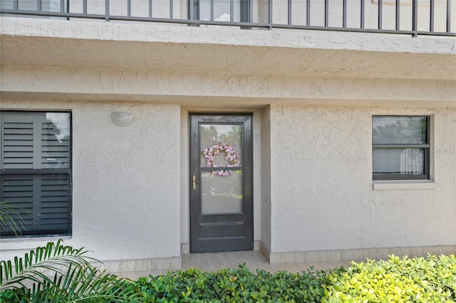 1001 Benjamin Franklin Dr Unit 106, Sarasota, FL 34236 - doorway to property with stucco siding