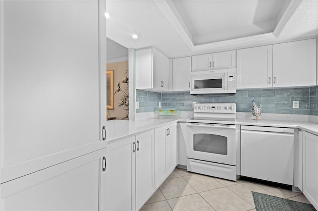 1001 Benjamin Franklin Dr Unit 106, Sarasota, FL 34236 - kitchen featuring white appliances, white cabinets, light tile patterned floors, decorative backsplash, and recessed lighting