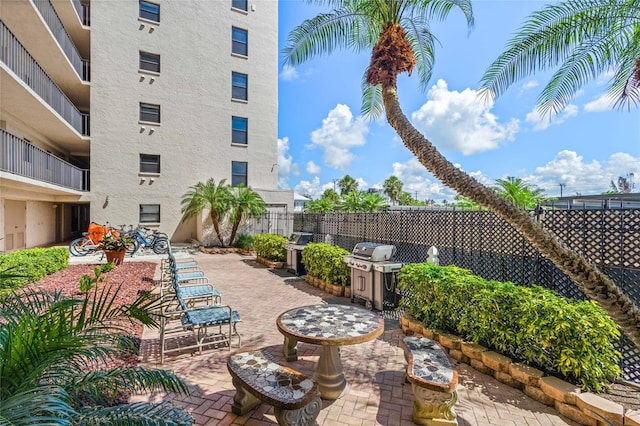 1001 Benjamin Franklin Dr Unit 106, Sarasota, FL 34236 - view of patio with a grill