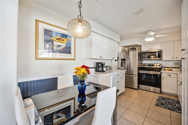 5808 SW 1st Pl, Cape Coral, FL 33914 - kitchen featuring appliances with stainless steel finishes, white cabinets, light countertops, backsplash, and light tile patterned flooring