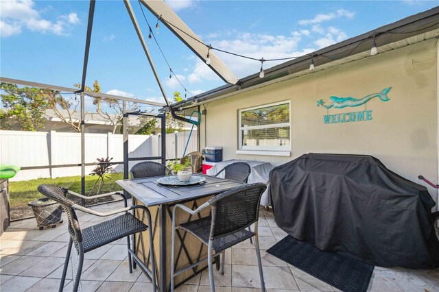 5808 SW 1st Pl, Cape Coral, FL 33914 - view of patio with outdoor dining space, fence, and glass enclosure