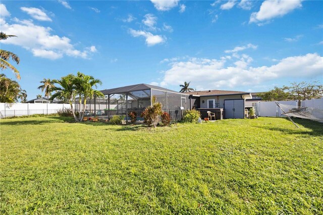 5808 SW 1st Pl, Cape Coral, FL 33914 - view of yard featuring a storage shed and glass enclosure