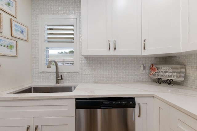 5623 Midnight Pass Rd Unit 615, Sarasota, FL 34242 - kitchen with stainless steel dishwasher, a sink, white cabinetry, and tasteful backsplash