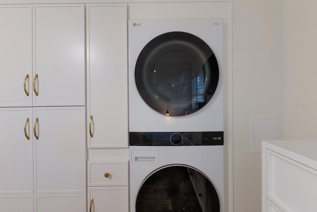 5623 Midnight Pass Rd Unit 615, Sarasota, FL 34242 - clothes washing area with cabinet space and stacked washer / dryer