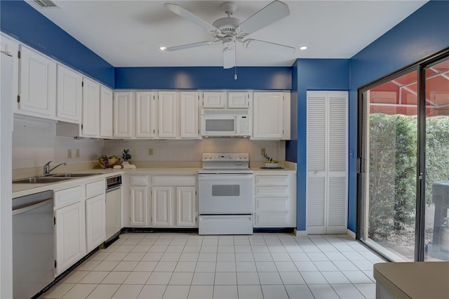5039 Kestral Park Dr Unit 67, Sarasota, FL 34231 - kitchen featuring white appliances, a sink, white cabinetry, and light countertops