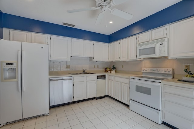 5039 Kestral Park Dr Unit 67, Sarasota, FL 34231 - kitchen featuring white appliances, light countertops, white cabinets, and recessed lighting