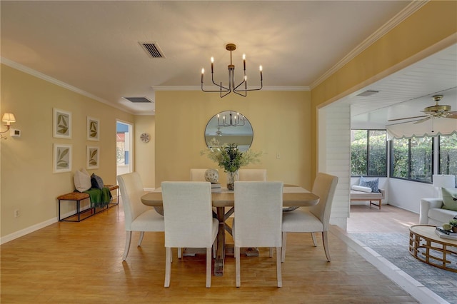 5039 Kestral Park Dr Unit 67, Sarasota, FL 34231 - dining room with a chandelier, light wood-style floors, crown molding, ceiling fan, and baseboards