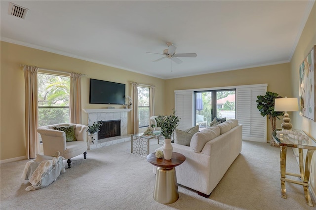 5039 Kestral Park Dr Unit 67, Sarasota, FL 34231 - carpeted living area featuring a fireplace, ceiling fan, ornamental molding, and baseboards