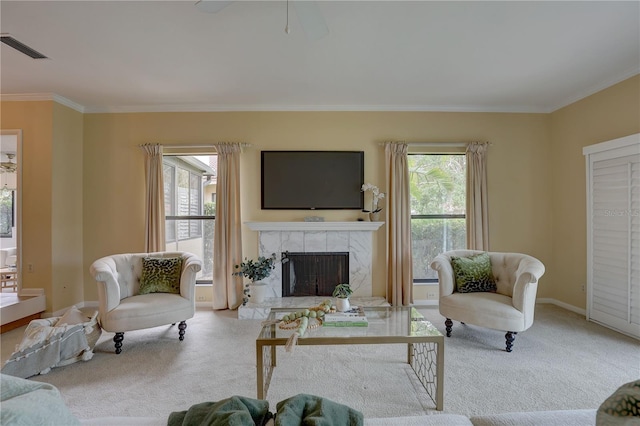 5039 Kestral Park Dr Unit 67, Sarasota, FL 34231 - living area featuring carpet, a tile fireplace, healthy amount of natural light, ornamental molding, and ceiling fan