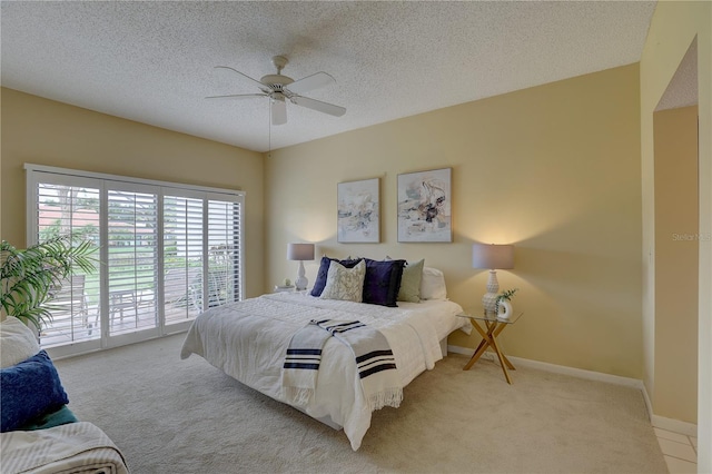5039 Kestral Park Dr Unit 67, Sarasota, FL 34231 - bedroom with access to exterior, carpet flooring, a ceiling fan, a textured ceiling, and baseboards