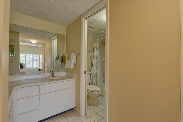 5039 Kestral Park Dr Unit 67, Sarasota, FL 34231 - ensuite bathroom featuring a textured ceiling, toilet, tile patterned flooring, vanity, and shower / bath combo