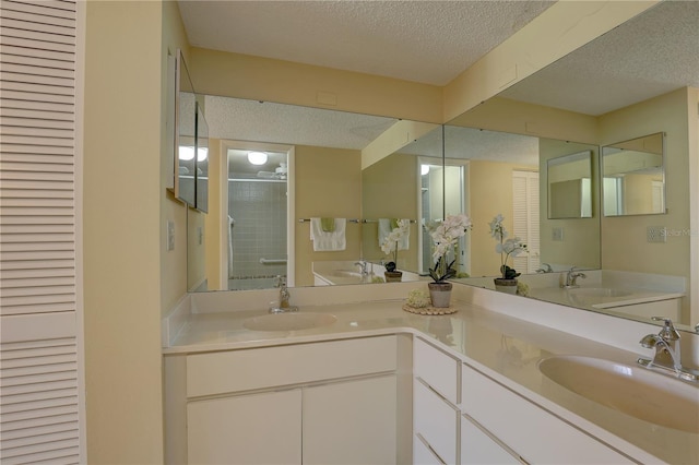 5039 Kestral Park Dr Unit 67, Sarasota, FL 34231 - full bathroom featuring a textured ceiling, a shower stall, double vanity, and a closet