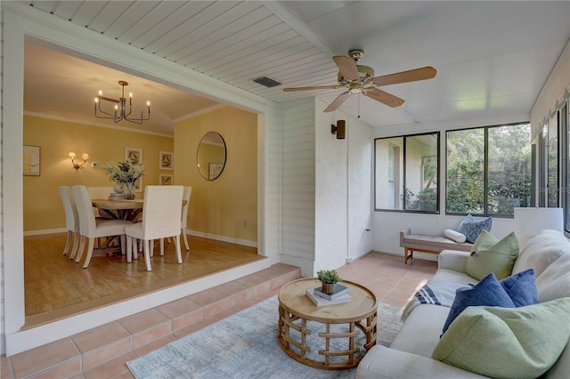 5039 Kestral Park Dr Unit 67, Sarasota, FL 34231 - living area featuring tile patterned floors, a chandelier, a ceiling fan, baseboards, and ornamental molding