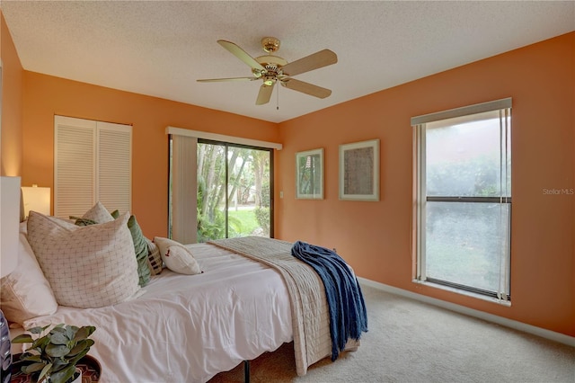 5039 Kestral Park Dr Unit 67, Sarasota, FL 34231 - bedroom featuring carpet flooring, a ceiling fan, baseboards, and a closet