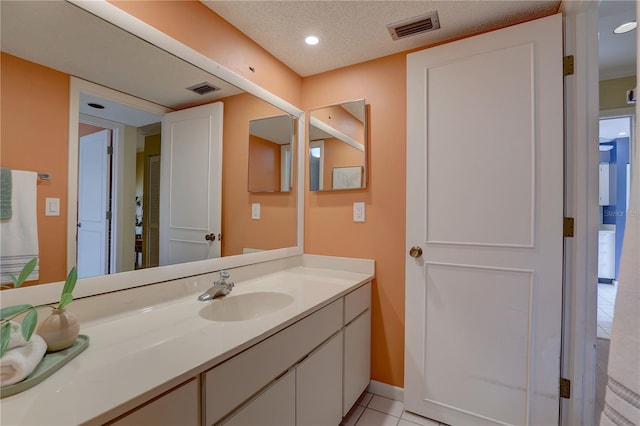 5039 Kestral Park Dr Unit 67, Sarasota, FL 34231 - bathroom featuring vanity, tile patterned floors, baseboards, and recessed lighting