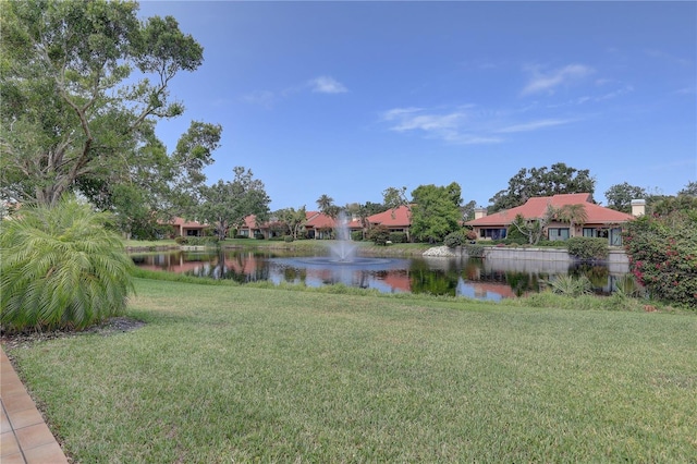 5039 Kestral Park Dr Unit 67, Sarasota, FL 34231 - view of green lawn featuring a water view