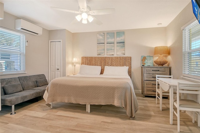 105 Casey Key Rd Unit 20, Nokomis, FL 34275 - bedroom featuring an AC wall unit, light wood-type flooring, ceiling fan, and a closet