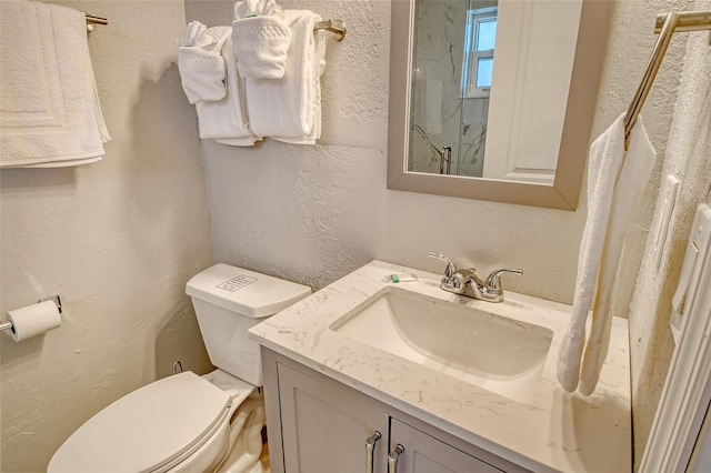 105 Casey Key Rd Unit 20, Nokomis, FL 34275 - bathroom with toilet, a textured wall, vanity, and a marble finish shower