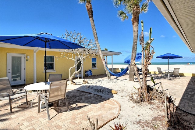 105 Casey Key Rd Unit 20, Nokomis, FL 34275 - view of patio / terrace featuring outdoor dining area and view of water and beach