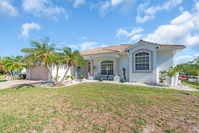 3620 Como St, Port Charlotte, FL 33948 - mediterranean / spanish home featuring an attached garage, a tiled roof, driveway, a front yard, and stucco siding