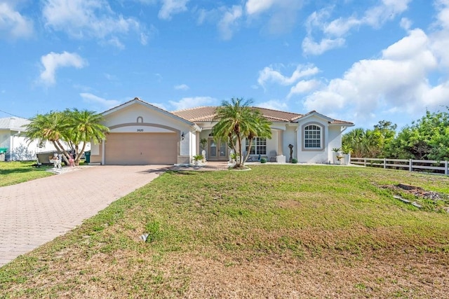 3620 Como St, Port Charlotte, FL 33948 - mediterranean / spanish-style home with decorative driveway, an attached garage, stucco siding, and a tiled roof