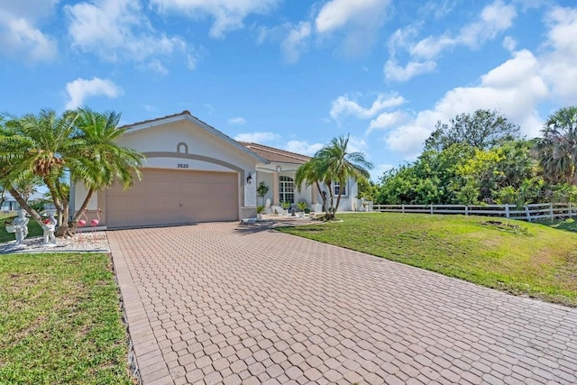 3620 Como St, Port Charlotte, FL 33948 - view of front of property with stucco siding, decorative driveway, and a garage