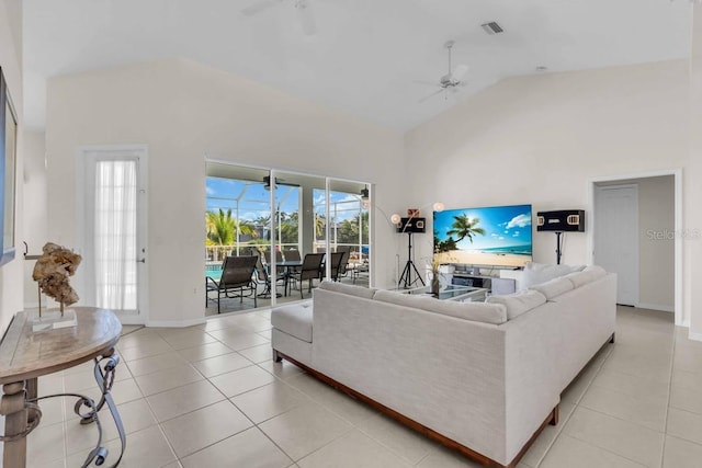 3620 Como St, Port Charlotte, FL 33948 - living room featuring a ceiling fan, light tile patterned floors, high vaulted ceiling, and baseboards