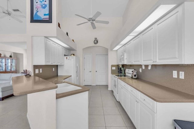 3620 Como St, Port Charlotte, FL 33948 - kitchen with white appliances, a ceiling fan, light tile patterned floors, and high vaulted ceiling