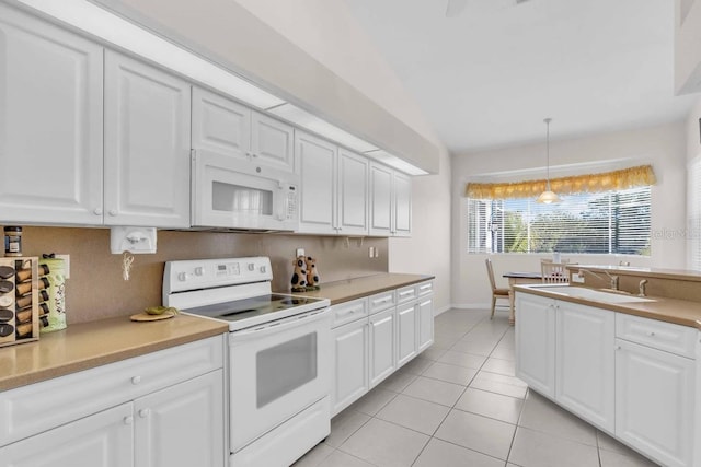 3620 Como St, Port Charlotte, FL 33948 - kitchen featuring white appliances, a sink, light countertops, white cabinetry, and light tile patterned floors