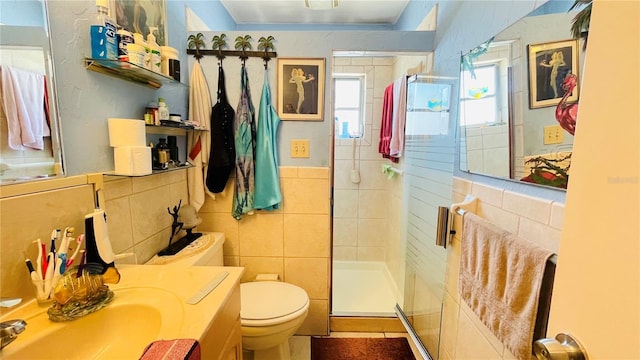 409 Bryn Mawr Is, Bradenton, FL 34207 - bathroom with a shower stall, toilet, vanity, and tile walls